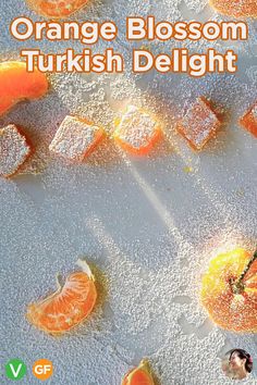 an orange blossom turkish delight is shown on the cover of this book, which features slices of oranges and cubes of powdered sugar