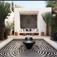 a black and white fountain in the middle of a courtyard