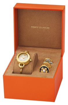 A signature, double-T logo decorates the dial of a goldtone bangle watch with three interchangeable charms. 27mm case; 5mm band width Three-hand quartz movement Mother-of-pearl dial Stainless steel/goldtone plate Imported Tory Burch Watch, Classy Watch, Watch Set, Bangle Watches, A Signature, Perfume Gift Sets, Fragrance Gift Set, Fabric Gift Bags, Bday Ideas