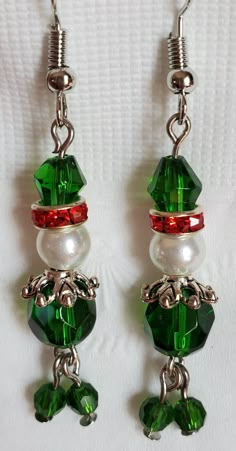 "A pair of Wiggley Elves are hand crafted on to each earring. These earrings are made with crystal and glass beads, strung on stainless steel , and attached to hypoallergenic, fish hook, ear wires. They measure \"approximately\" 1-1/2\" long from ear hole to the bottoms. EXTREEMELY Lightweight!  They are attached to a ready-hang card for display or gift giving. Ready to ship immediately!" Christmas Dangle Earrings, Elf Earrings, Christmas Earrings Handmade, Santa Earrings, Christmas Jewelry Diy, Christmas Beading, Diy Earrings Easy, Homemade Earrings, Diy Wire Jewelry