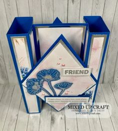 a blue and white card with flowers on it