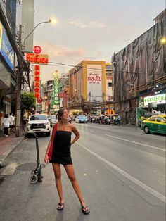 a woman standing in the middle of an empty street