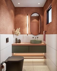 a bathroom with a toilet, sink and mirror in it's center wall area