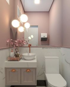 a white toilet sitting next to a sink in a bathroom under a mirror and lights