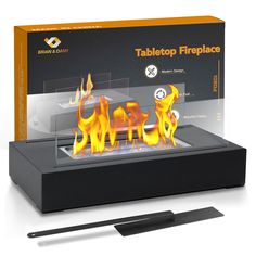 the tabletop fireplace is set up in front of a box