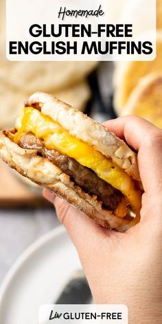 a person holding a sandwich in their hand with the words homemade gluten - free english muffins