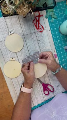 the woman is working on her crafts with scissors and other crafting supplies, including paper plates