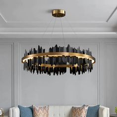 a living room with a white couch and a large chandelier hanging from the ceiling