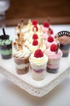 small desserts are arranged on a white tray