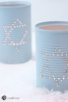 two blue tin canisters with gold stars on them