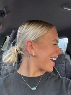 a woman sitting in the back seat of a car with her eyes closed and smiling