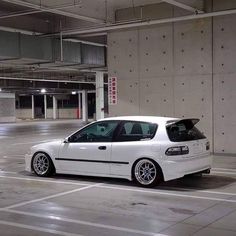 a white car parked in an empty parking garage