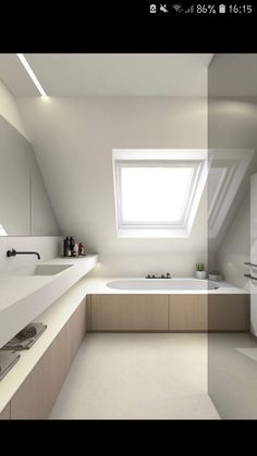 an attic bathroom with skylight and bathtub