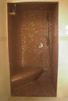 a bathroom with a shower and tiled walls