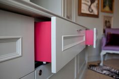 a close up of a drawer with pink paper on the drawers and zebra print rug in the background