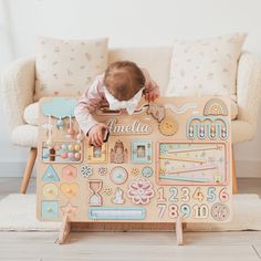 a baby is playing with a wooden toy