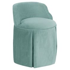 an upholstered chair with a pleaed skirt