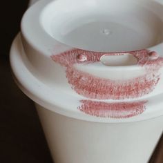 a close up of a cup with lipstick on it