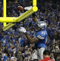 a football player catching a ball in the air