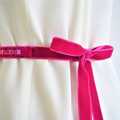 Add a gorgeous flash of colour to your wedding dress or bridesmaid dress with my handmade velvet sash belt. This luxurious bridal sash features hand-stitched beads on sumptuous velvet and is perfect for weddings with a bright jewel colour or geometric theme. I love the glass bugle beads used in this design and the subtle Art Deco feel. It works beautifully for brides and bridesmaids and is a lovely way to accentuate the waistline of your dress. The fuschia pink, deep magenta colour looks gorgeou Elegant Fitted Pink Sashes, Pink Bridal Belt With Sashes For Party, Pink Sashes Bridal Belt For Wedding, Adjustable Ribbon Wedding Sashes, Adjustable Sashes Bridal Belt For Party, Adjustable Bridal Belt With Sashes For Party, Bride Belt, Magenta Colour, Bridesmaid Sash