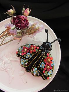 a small butterfly on a plate with flowers