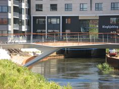 a bridge over a body of water in front of a building