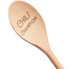 a wooden spoon with the words chilli champion engraved on it's side, in front of a white background