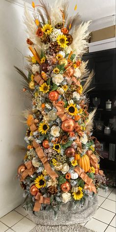 a decorated christmas tree with sunflowers and feathers