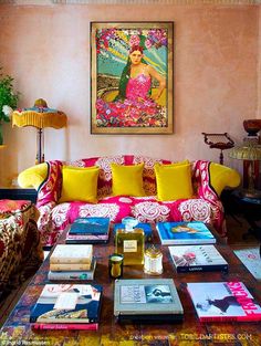 a living room filled with lots of furniture and books on top of a coffee table