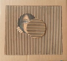 a cardboard box with an image of a woman's face in the middle of it