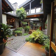 an outdoor patio with potted plants on the floor and stairs leading up to it