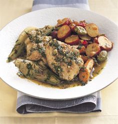 a white plate topped with chicken and vegetables