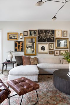 a living room filled with furniture and pictures on the wall