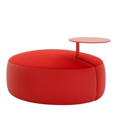 a red coffee table sitting on top of a white floor next to a round table