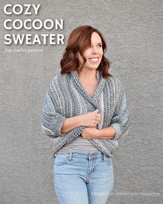 a woman standing in front of a gray wall with her arms crossed and smiling at the camera