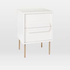 a small white cabinet with wooden legs