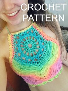 a woman wearing a multicolored crochet top smiling at the camera with her hand on her hip