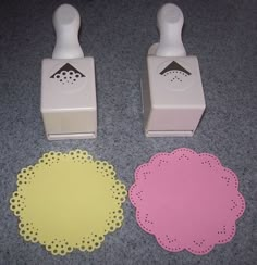 two rubber stampers and some paper doilies on the floor next to each other