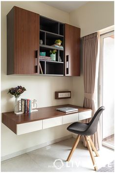 a desk with a chair and some books on it next to a sliding glass door