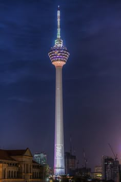 a very tall tower with a sky scraper in the middle of it's top