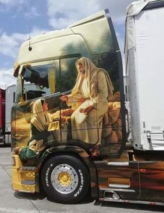 a large semi truck with the image of jesus on it's side