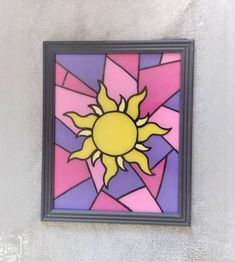 the sun is depicted in this colorful stained glass piece on the wall above it's doorway