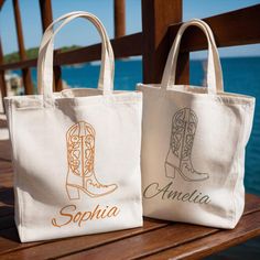 two personalized canvas bags sitting on top of a wooden bench