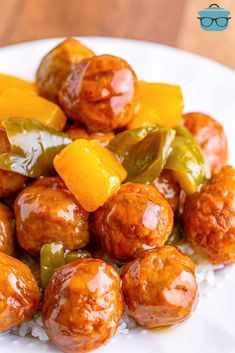 a white plate topped with meatballs and peppers