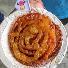 there is a paper plate that has some kind of onion rings on top of it