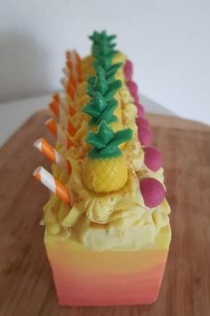 a cupcake with pineapples and candy on top