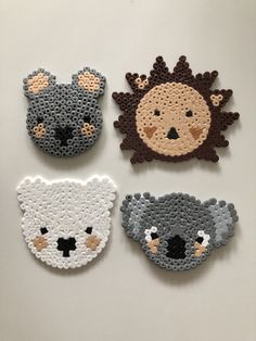 four crocheted animal magnets on a white surface