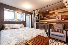 a bed room with a neatly made bed next to a chair and a window in it