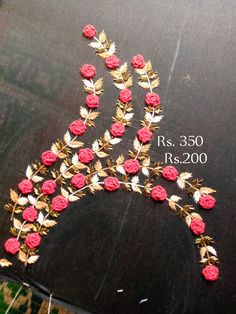 a tiara made out of red roses and gold leaves