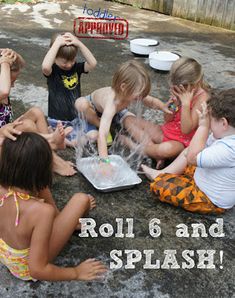 there are many children sitting on the ground playing with soap and water in their hands